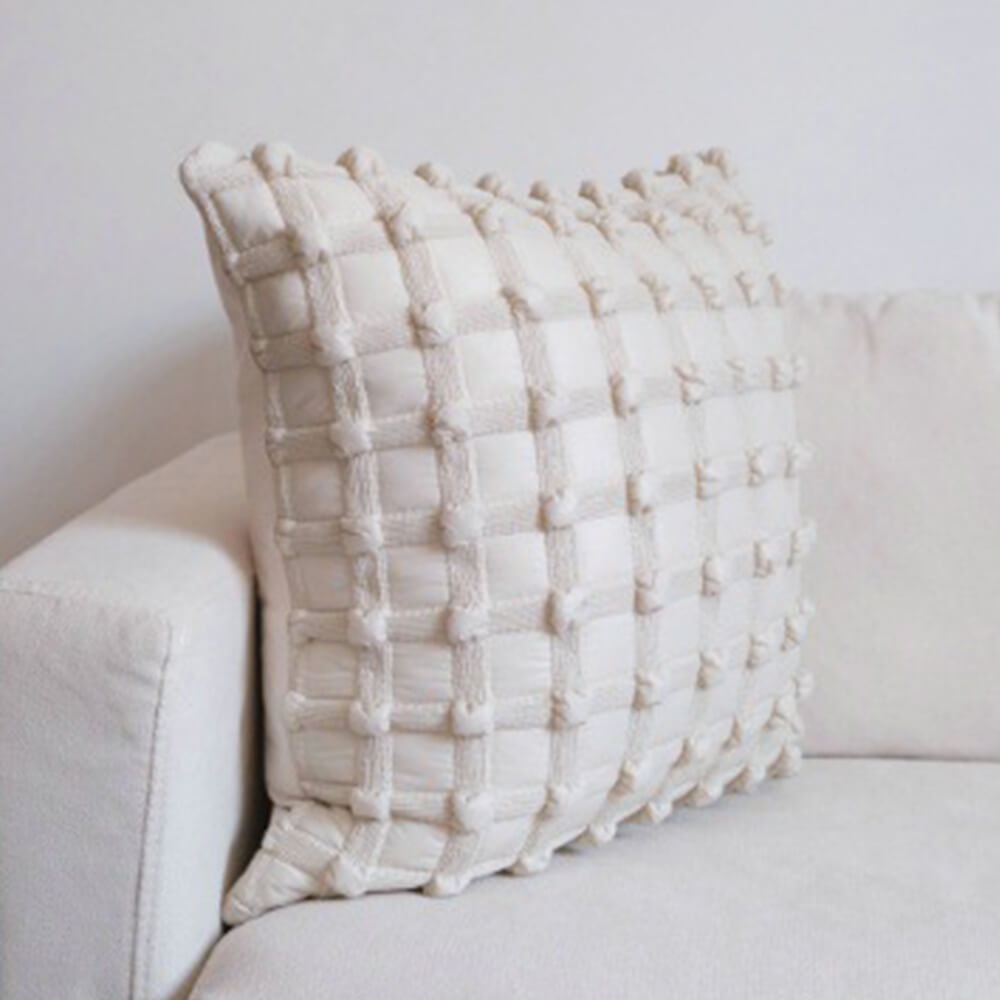 Luxury decorative checkered cushion for lumbar support on sofa at home.
