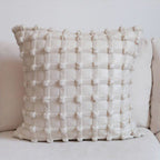 Luxury decorative checkered cushion for lumbar support on sofa at home.