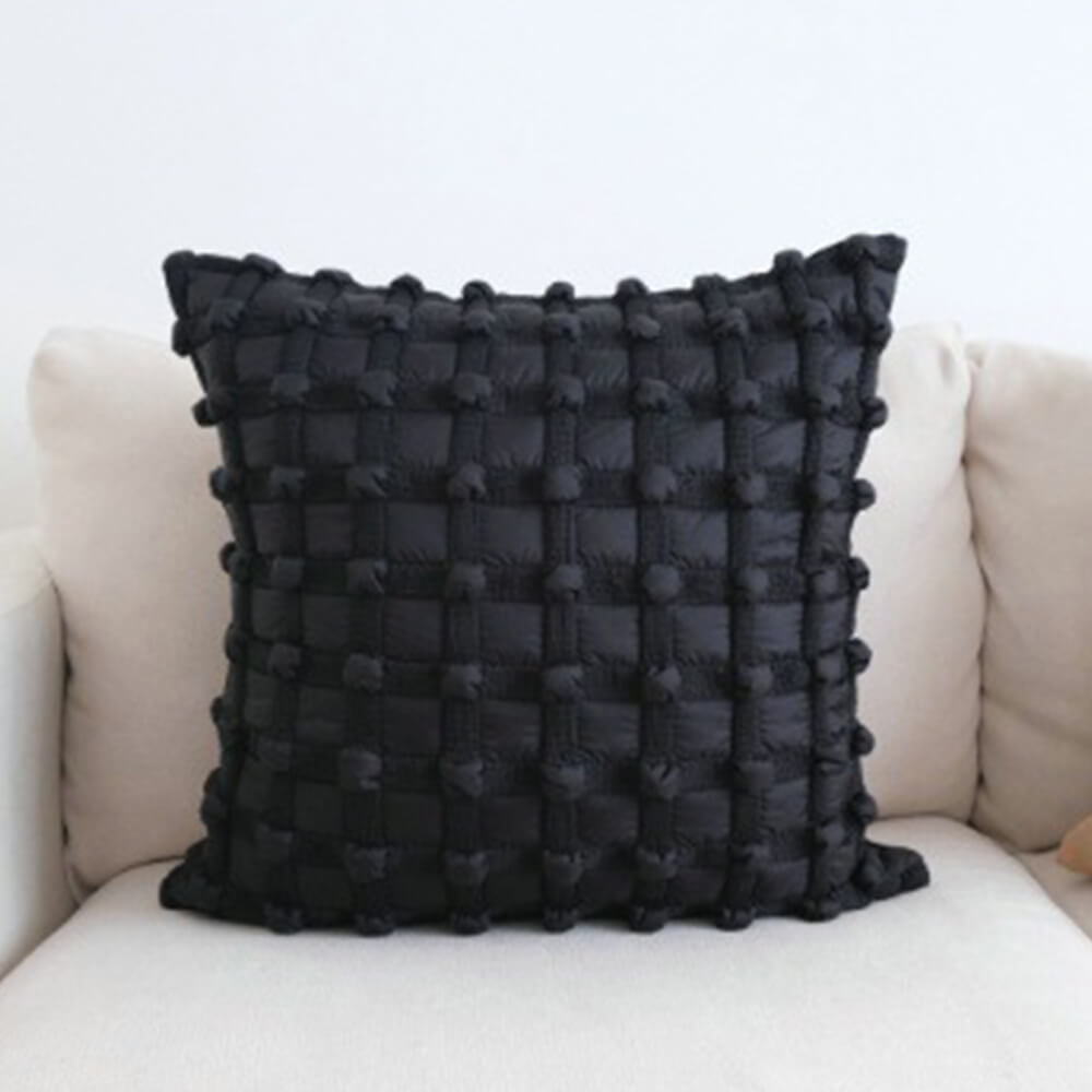 Luxury decorative checkered cushion for lumbar support on sofa at home.