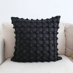 Luxury decorative checkered cushion for lumbar support on sofa at home.
