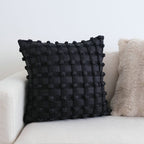 Luxury decorative checkered cushion for lumbar support on sofa at home.