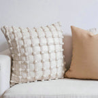 Luxury decorative checkered cushion for lumbar support on sofa at home.