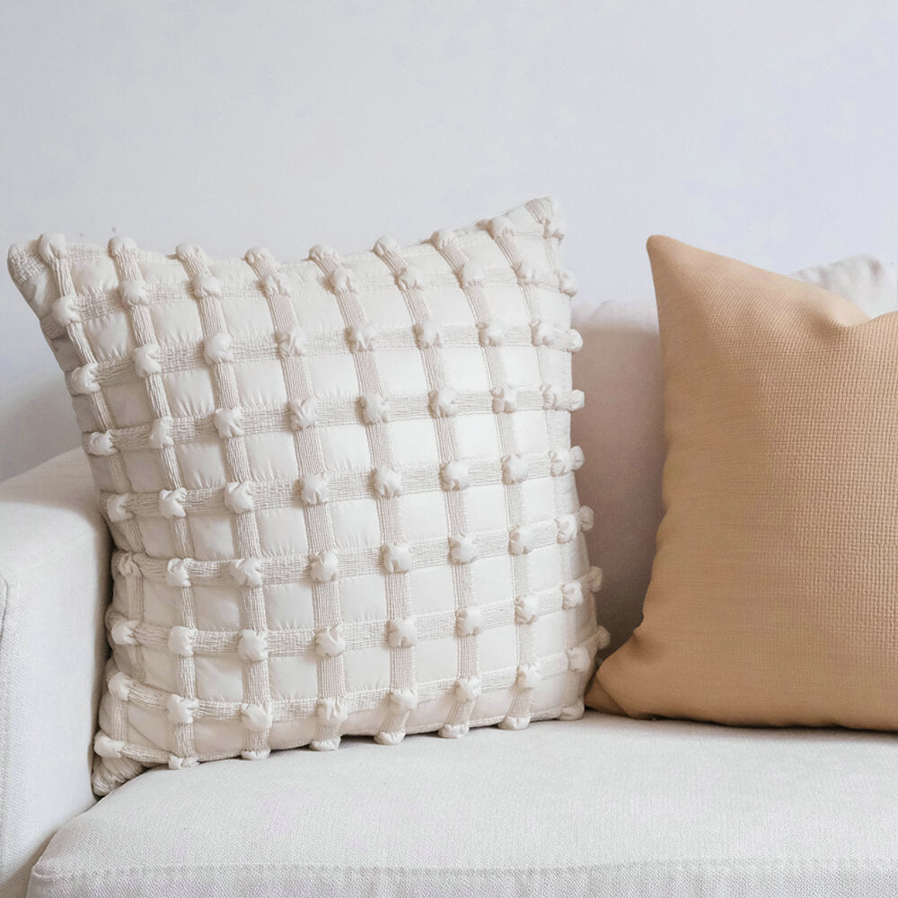 Luxury decorative checkered cushion for lumbar support on sofa at home.