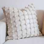 Luxury decorative checkered cushion for lumbar support on sofa at home.