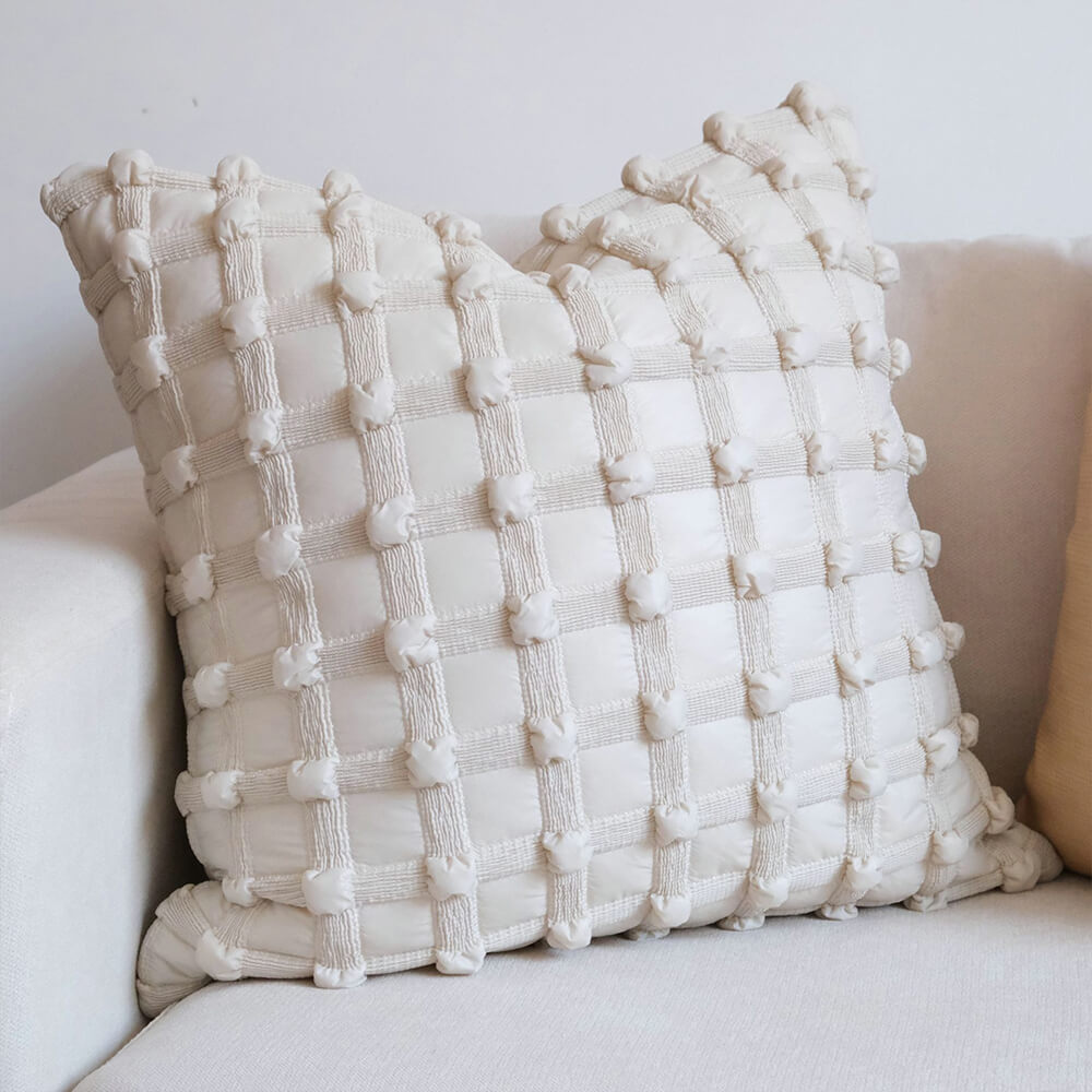 Luxury decorative checkered cushion for lumbar support on sofa at home.